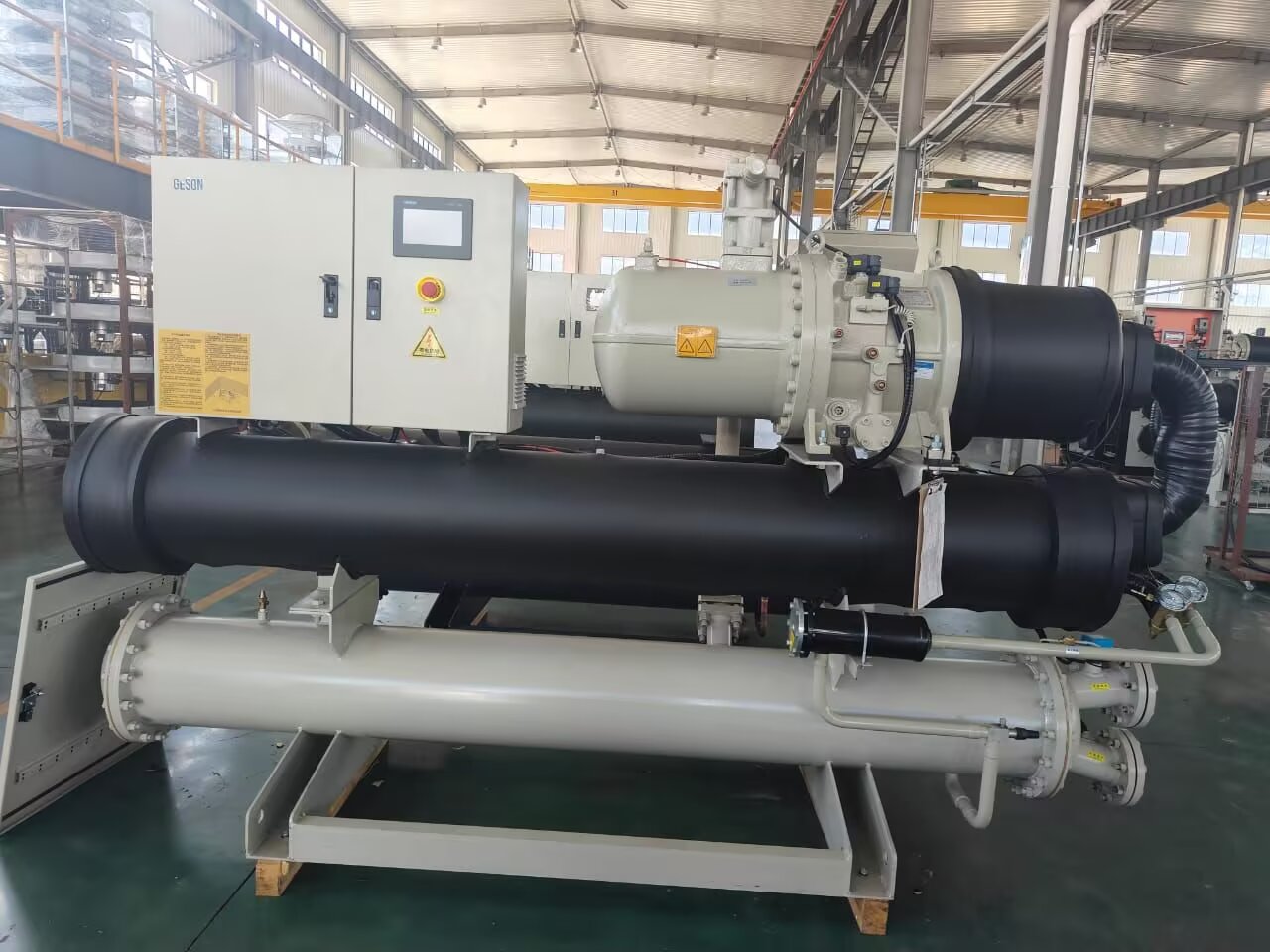 Water cooled screw chiller assembly with compressor, control cabinet and heat exchanger